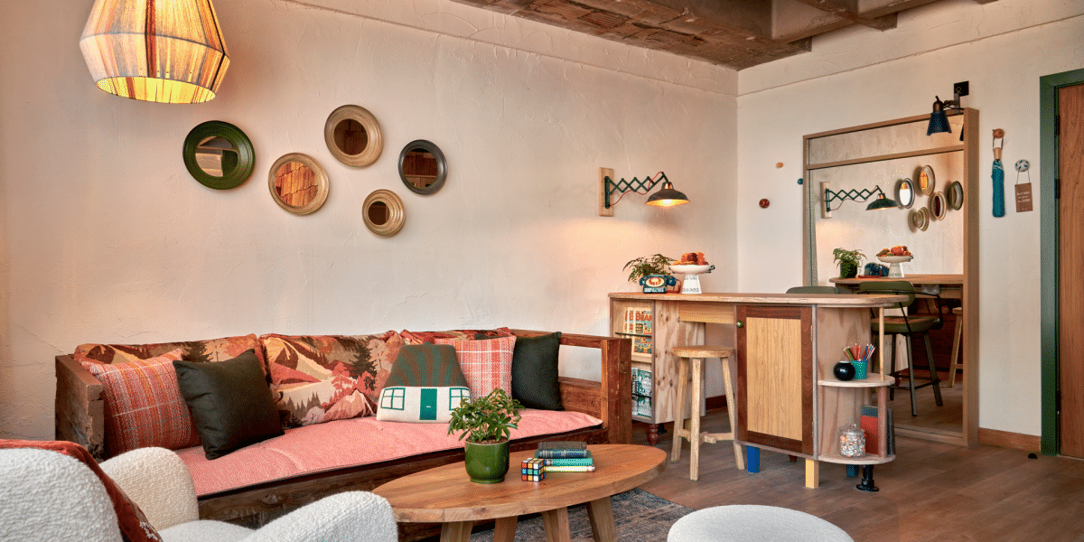 Living area of Treehouse Hotel Manchester Studio Suite furnished with couch, coffee table, and bar