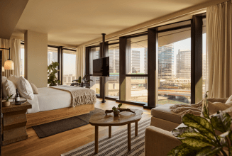 1 Hotel Melbourne River Suite Bedroom with floor-to-ceiling windows overlooking the city's Yarra River