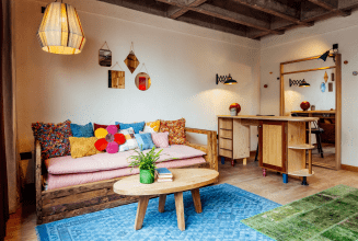 Sofa with various colourful pillows in seating area.