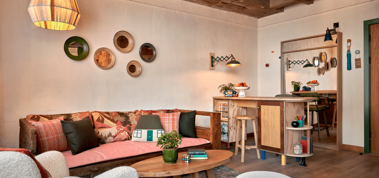 Living area of Treehouse Hotel Manchester Studio Suite furnished with couch, coffee table, and bar